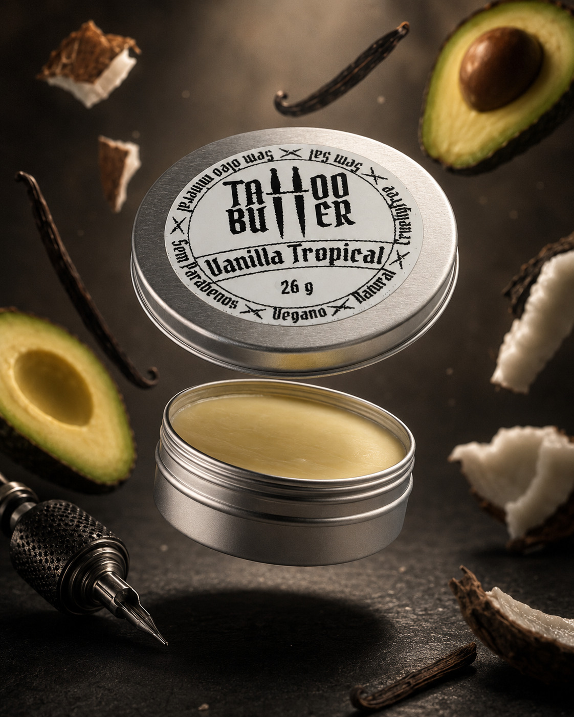 tattoo-butter-vanilla-tropical-matchii-26g-coco-abacate-baunilha Latinha de alumínio com tampa aberta com manteiga para tatuagem de abacate, rodeado por pedaços de coco, abacate, favas de baunilha e máquina de tatuagem.